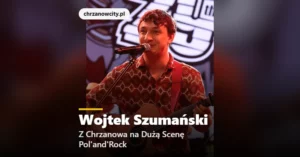 Wojtek Szumański śpiewa z gitarą przy mikrofonie na scenie festiwalu